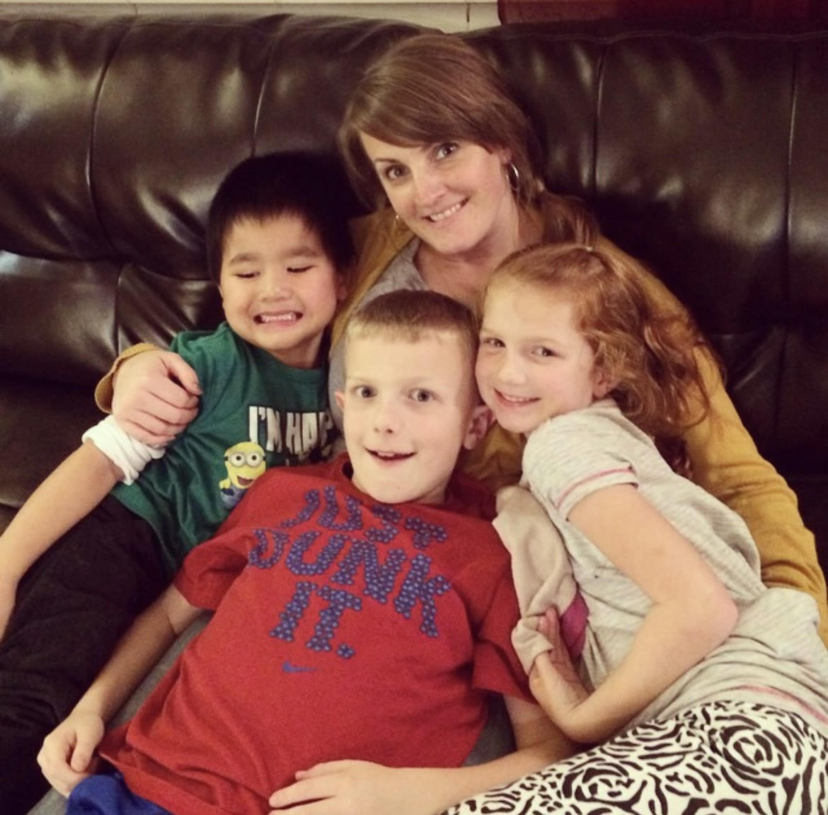 Three kids crammed on mom's lap.